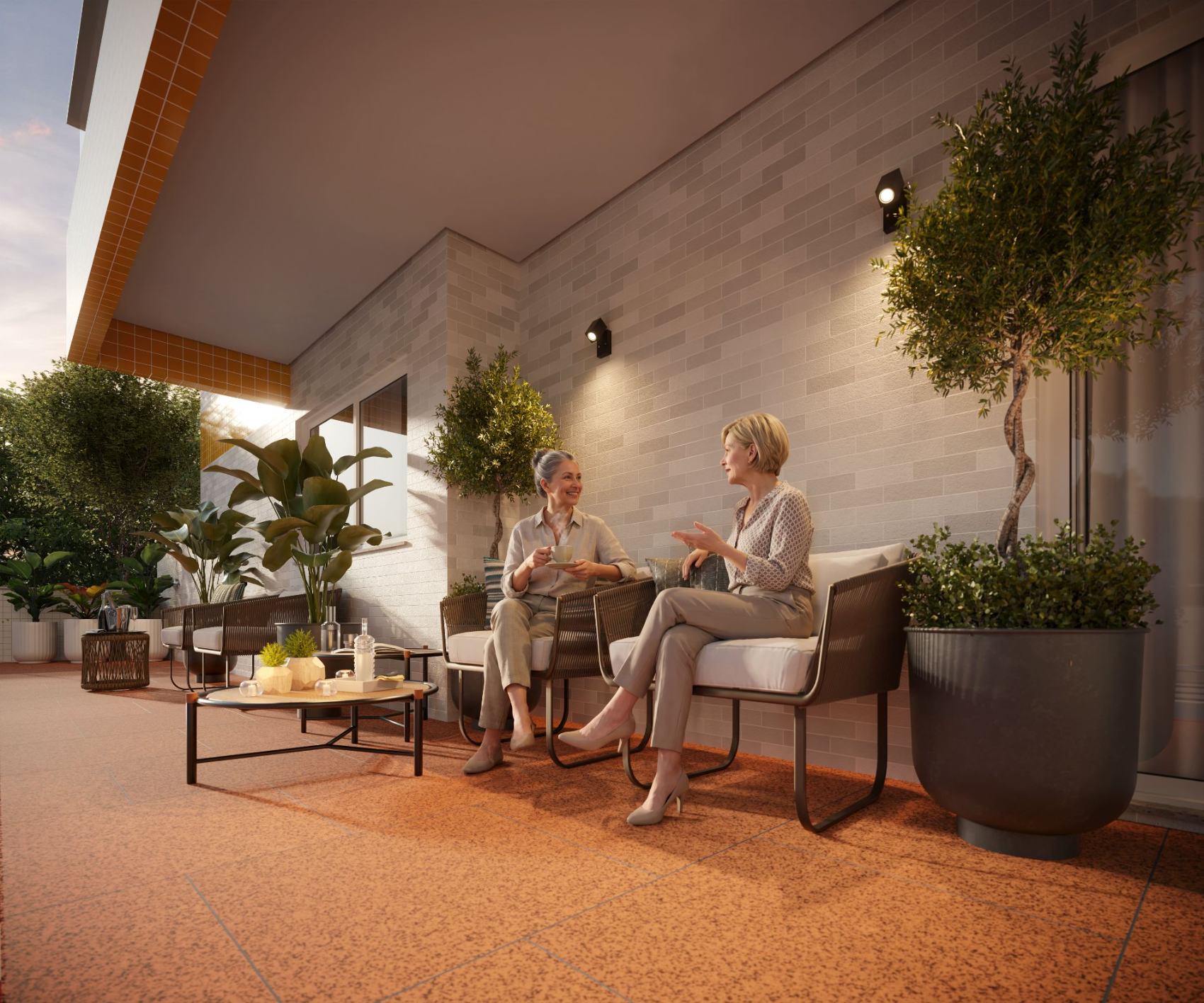 Espaço mãe e bebê com poltronas e vegetação no terraço