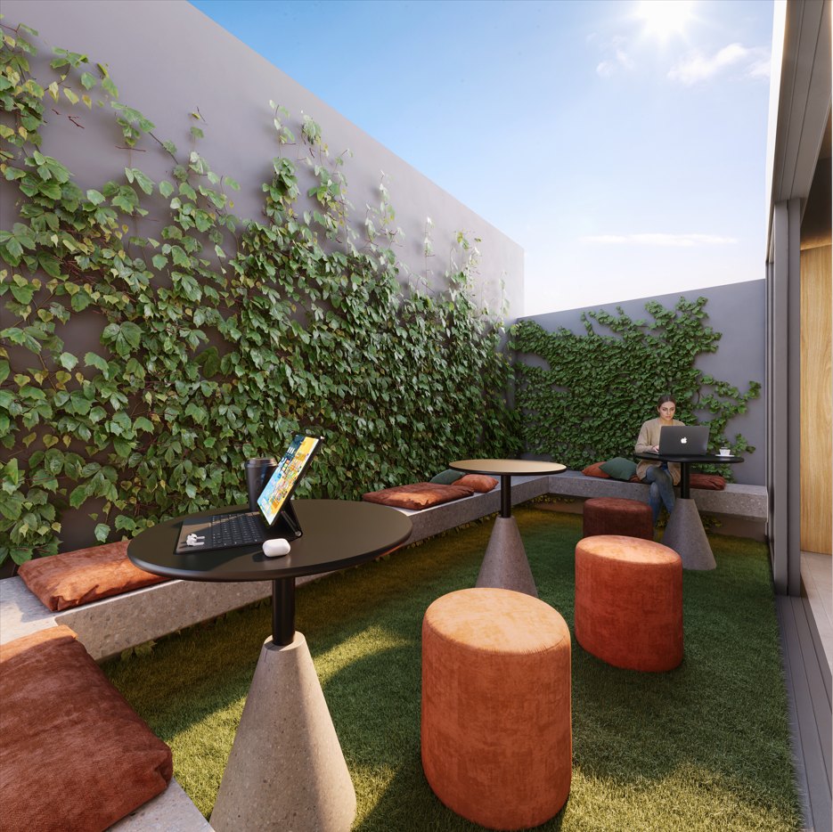Coffee garden de dia, com parede verde e bancos de concreto